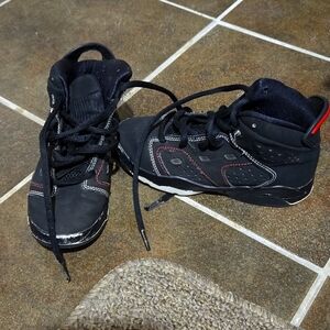 Kids black Jordans with red trim